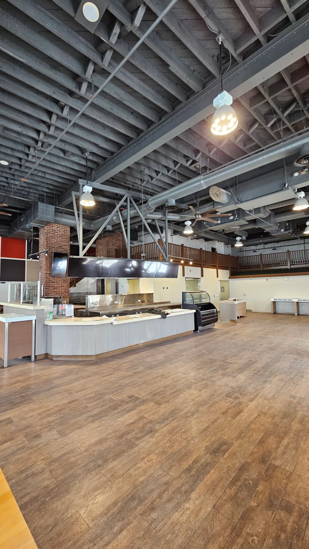 Wide restaurant interior with exposed ceiling and service counter